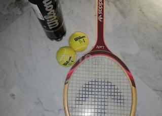 Raquette de tennis Adidas et balles de tennis. 