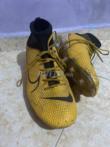 A black and yellow pairs of football boots 