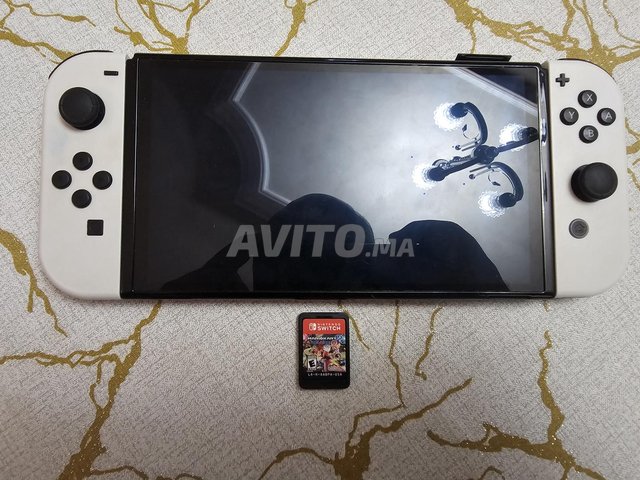 Nintendo switch oled avec jeux Mario kart deluxe 