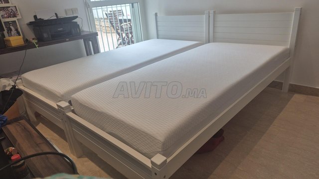 سرير من الخشب الأبيض وفراش جديد