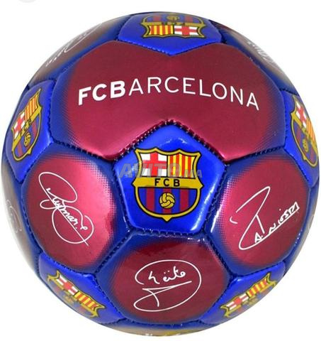 Ballon de football avec le logo du FC Barcelone et signatures de joueurs.