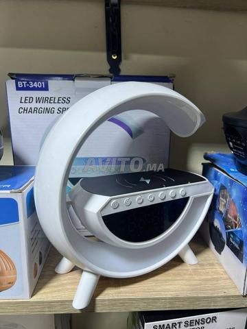 Haut-parleur sans fil avec chargeur LED et horloge numérique.