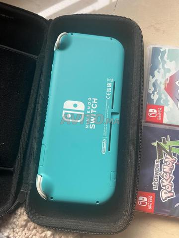 جهاز Nintendo Switch Lite تركوازي مع 4 ألعاب وغلاف - 2